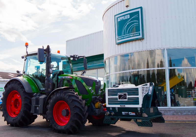 An Applied Varimount 350 being driven by a tractor outside of the Applied PI building